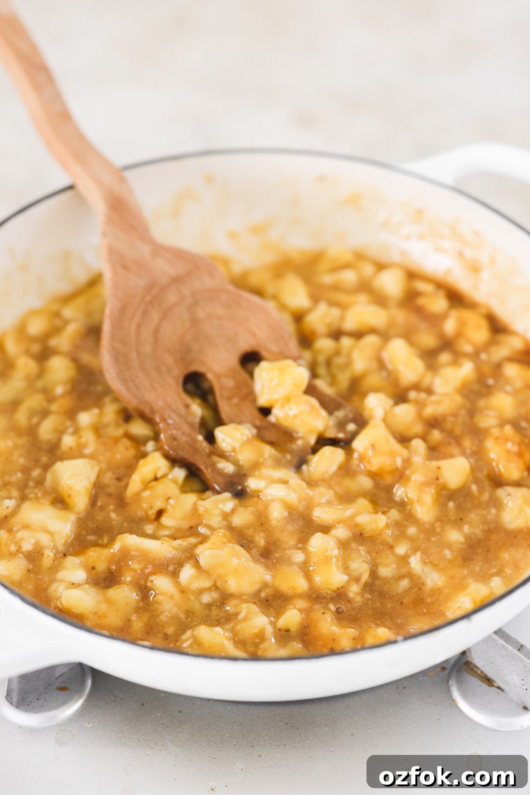 Vegan Homemade Banana Jam Recipe: Simple Step-by-Step Guide 5 a wooden spoon stirring the banana mixture in a skillet