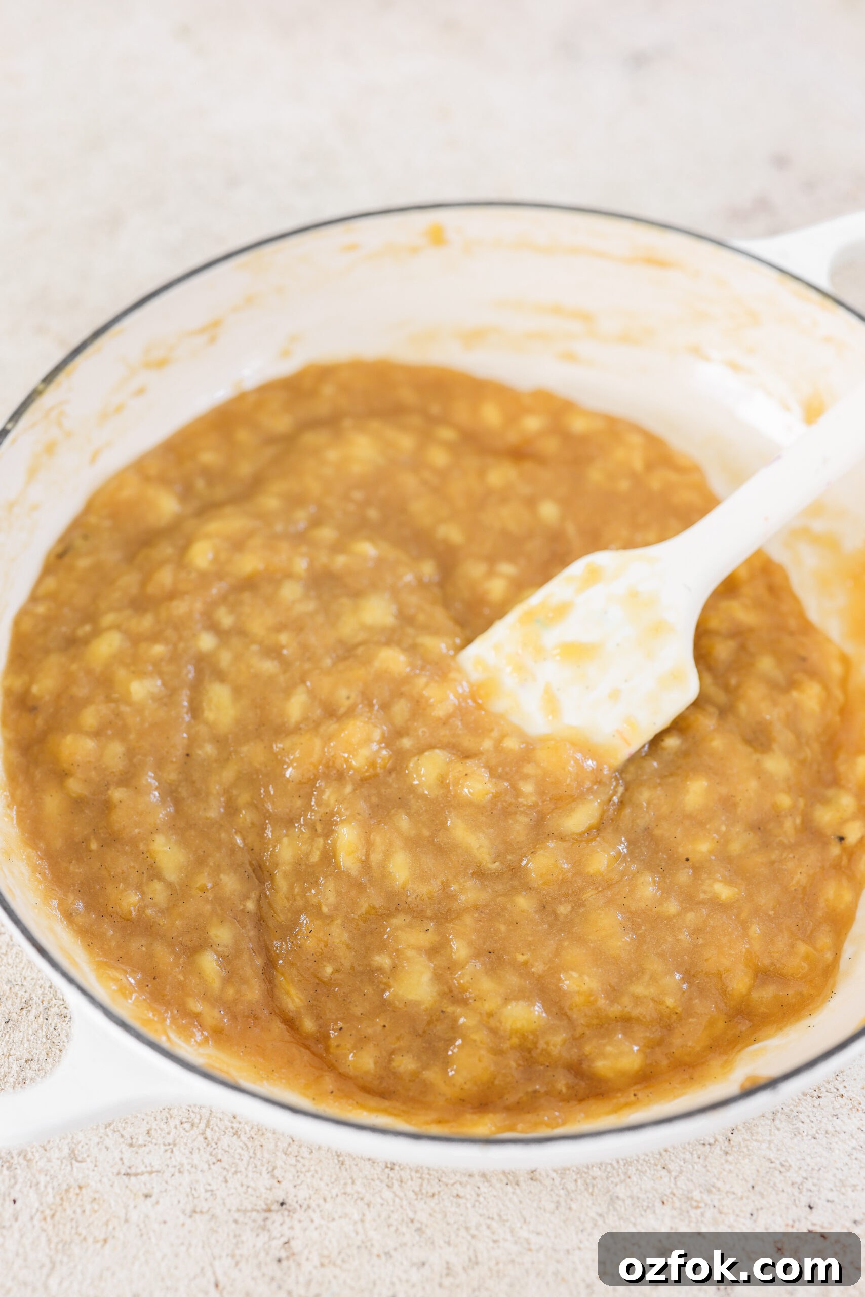 Vegan Homemade Banana Jam Recipe: Simple Step-by-Step Guide 6 a white spatula stirring banana jam in a skillet