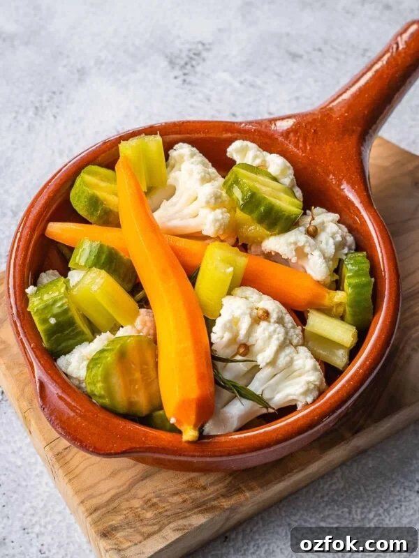 Pickled Italian vegetables in a small crock.