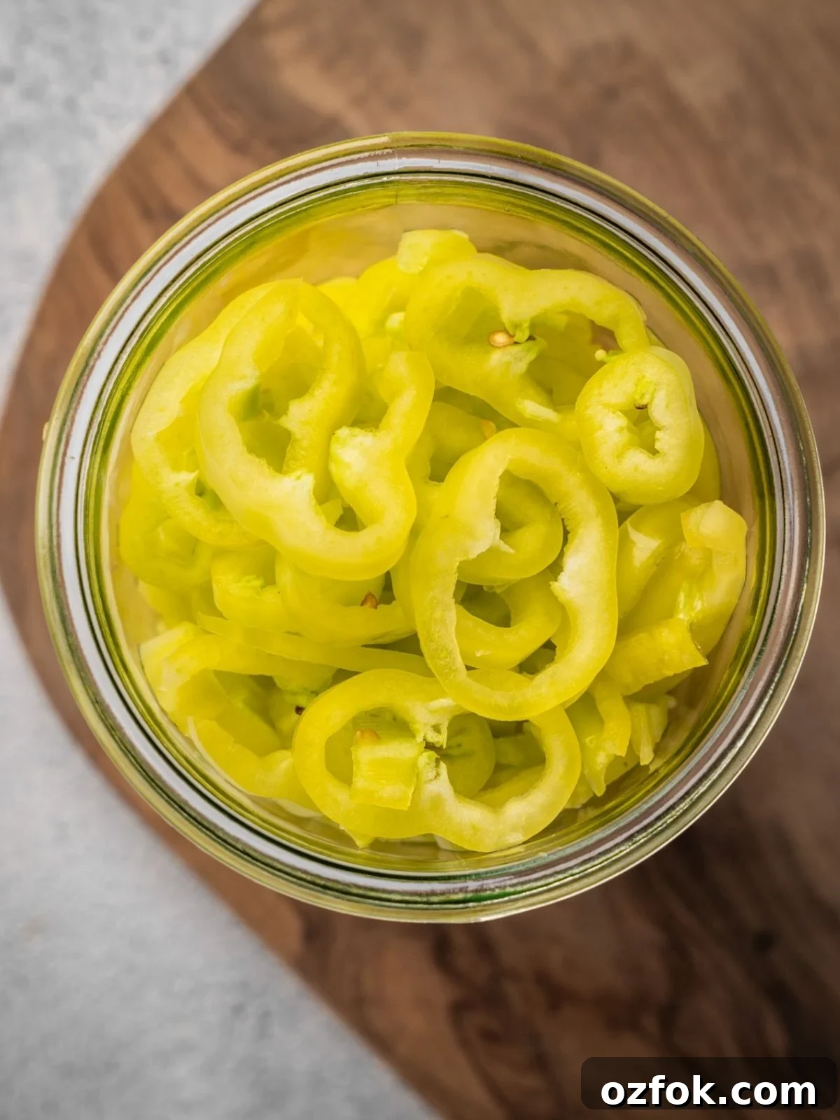A mason jar packed with pepper rings.