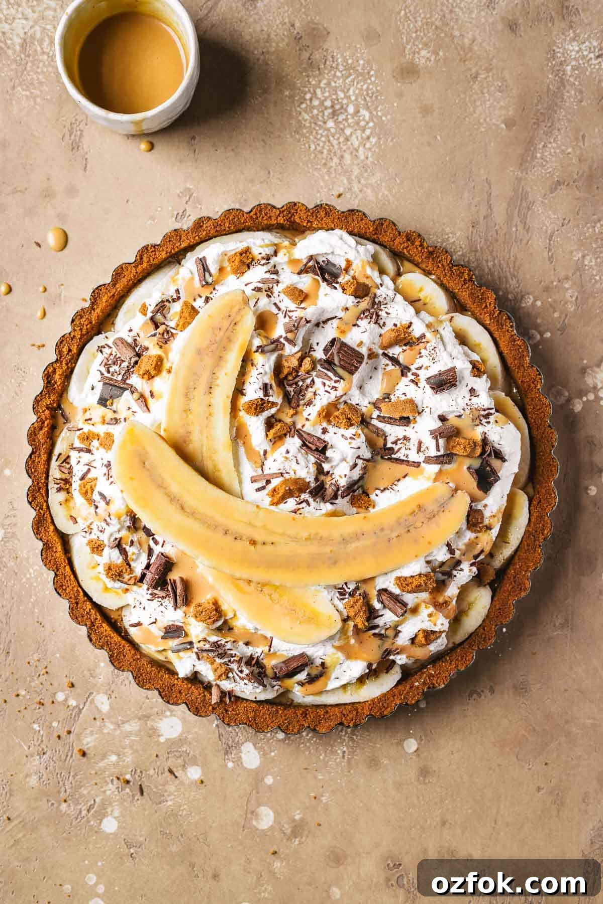 Banoffee Tart Recipe: Caramelized Banana Tart with Buttery Crust 12 A banoffee tart topped with sliced banana, chocolate shavings, biscoff crumbles and dulce de leche sauce.