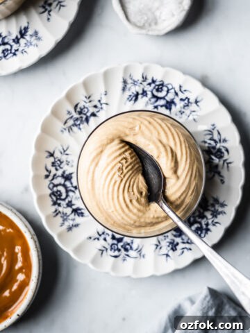 A thin glass cup holds circular swirls of piped dulce de leche mousse.