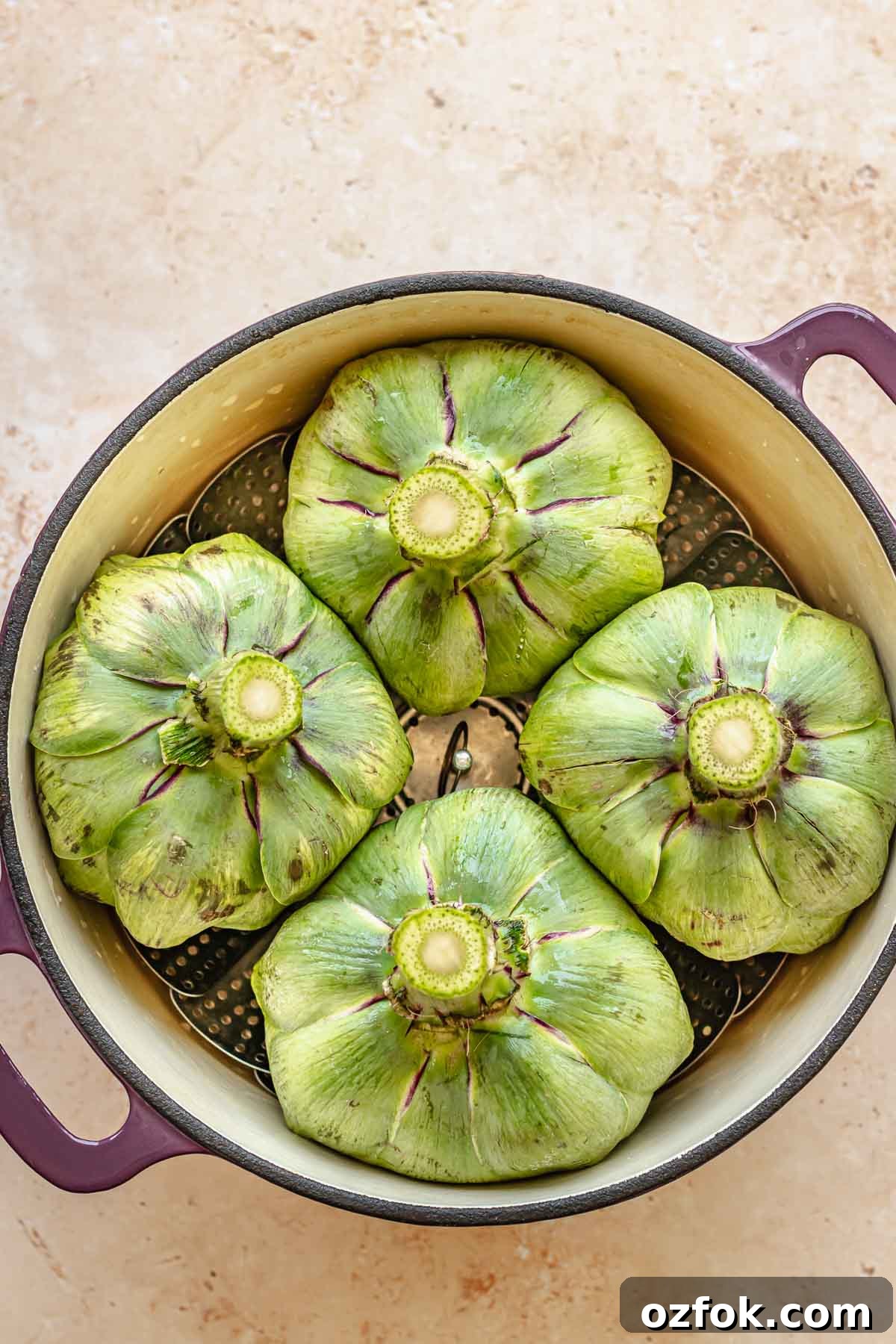 Grilled Marinated Artichokes with Lemon Aioli Recipe 7 Artichokes in a pot with the bottom sides up.