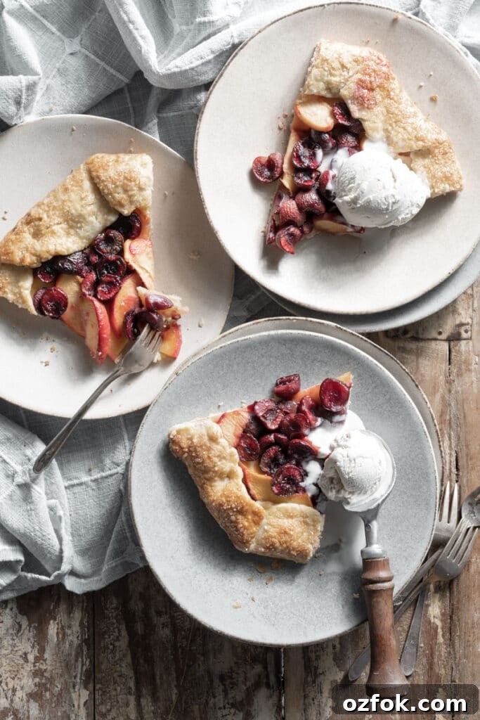 Peach and Cherry Galette Recipe with Flaky Golden Crust 4 Three slices of fruit pie on plates topped with vanilla ice cream.