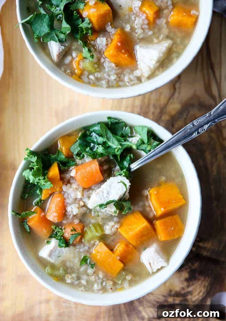 Turkey, Sweet Potato & Kale Buckwheat Soup Recipe 6 A bowl of soup on a table, with a spoon in it