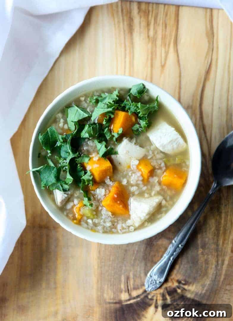 Turkey, Sweet Potato & Kale Buckwheat Soup Recipe 7 Buckwheat soup with turkey, sweet potato & kale in a white bowl on a wooden board