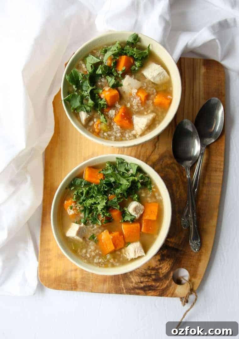 Turkey, Sweet Potato & Kale Buckwheat Soup Recipe 8 Two bowls of soup on a cutting board, with two spoons