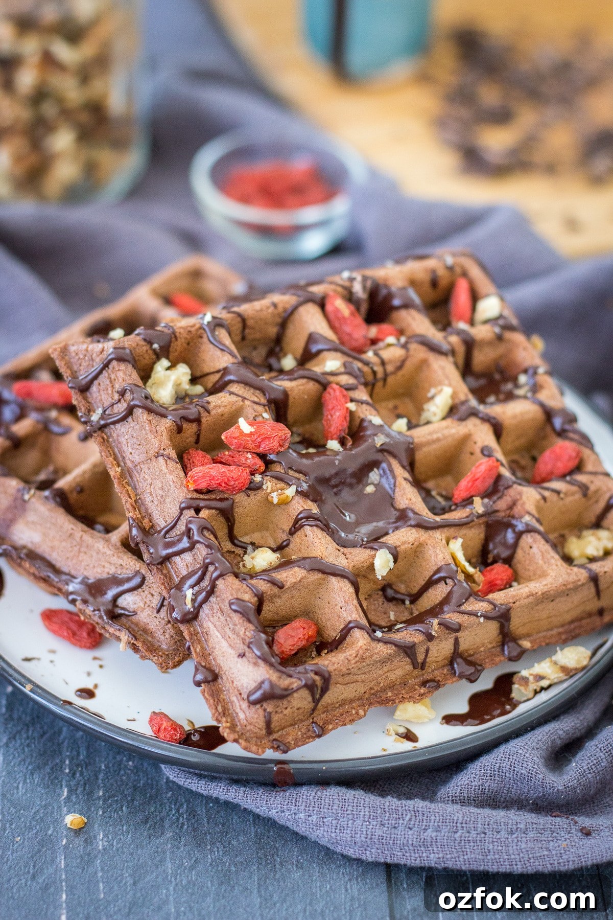 Decadent Chocolate Waffle Recipe for Breakfast or Dessert 2 Chocolate waffles served on a plate drizzled with melted chocolate