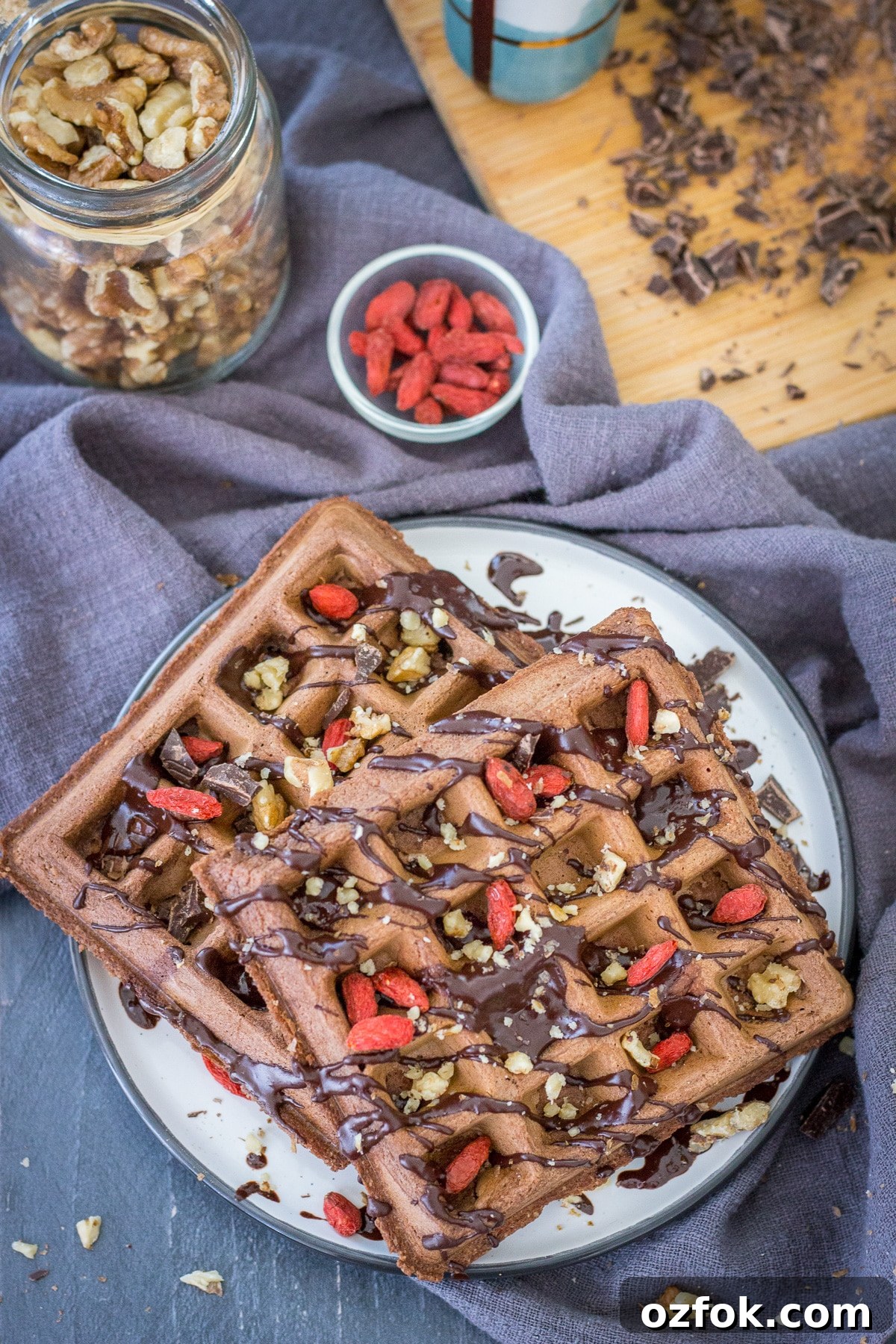 Decadent Chocolate Waffle Recipe for Breakfast or Dessert 6 Upper view of Chocolate waffles served on a plate drizzled with melted chocolate
