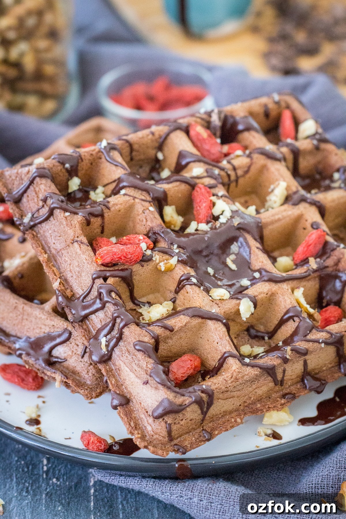 Decadent Chocolate Waffle Recipe for Breakfast or Dessert 7 Chocolate waffles served on a plate drizzled with melted chocolate
