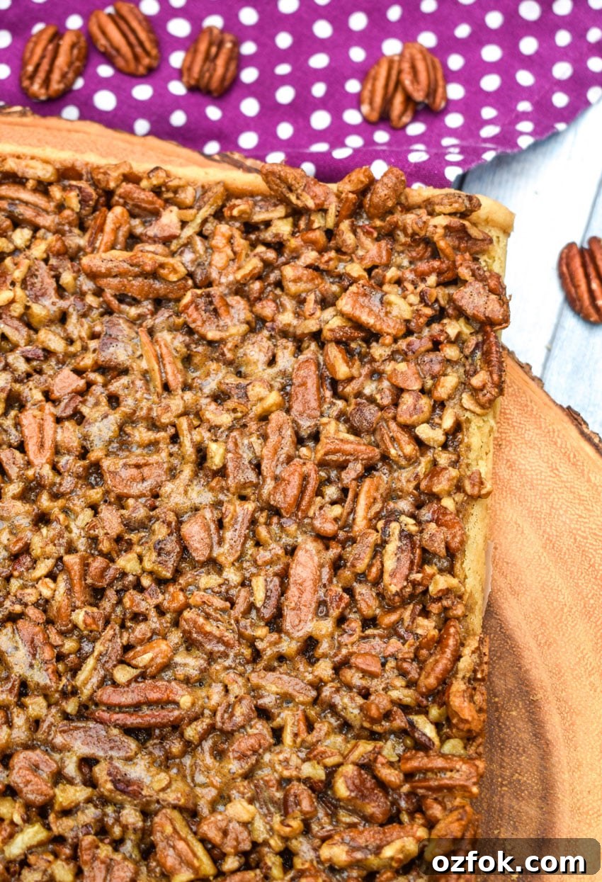 Chewy Pecan Pie Bars with Buttery Shortbread Crust 4 homemade pecan pie bars on a wooden cutting board
