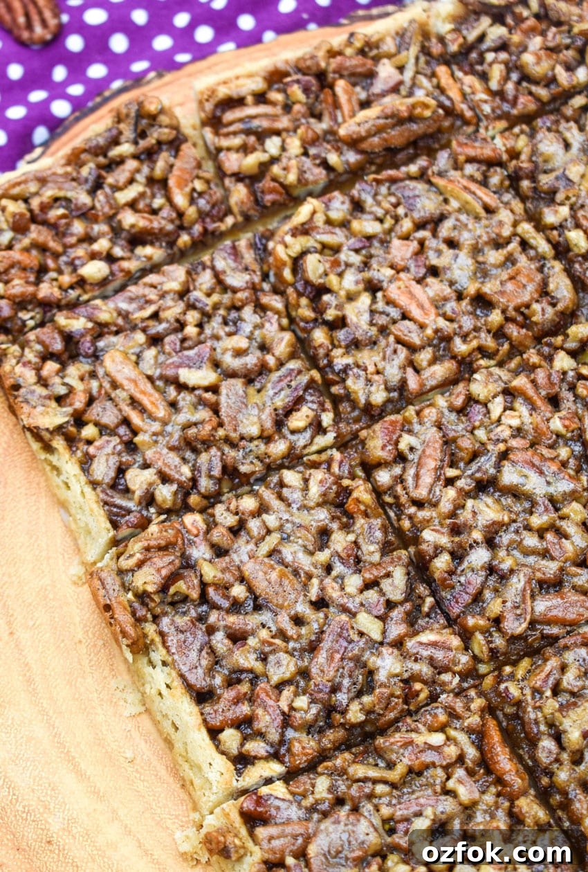 Chewy Pecan Pie Bars with Buttery Shortbread Crust 5 sliced homemade pecan pie bars on a wooden cutting board