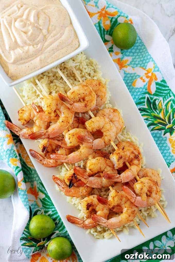 Key Lime Grilled Shrimp with Creamy Aioli Sauce 5 Grilled shrimp skewers over rice with a square bowl of key lime aioli.