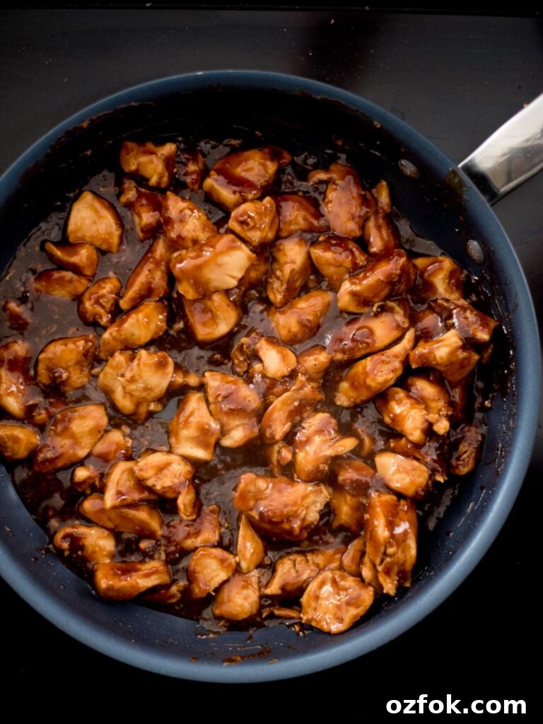Classic Homemade General Tso's Chicken Recipe for Dinner 6 A frying pan with chicken chunks in a General Tso sauce.
