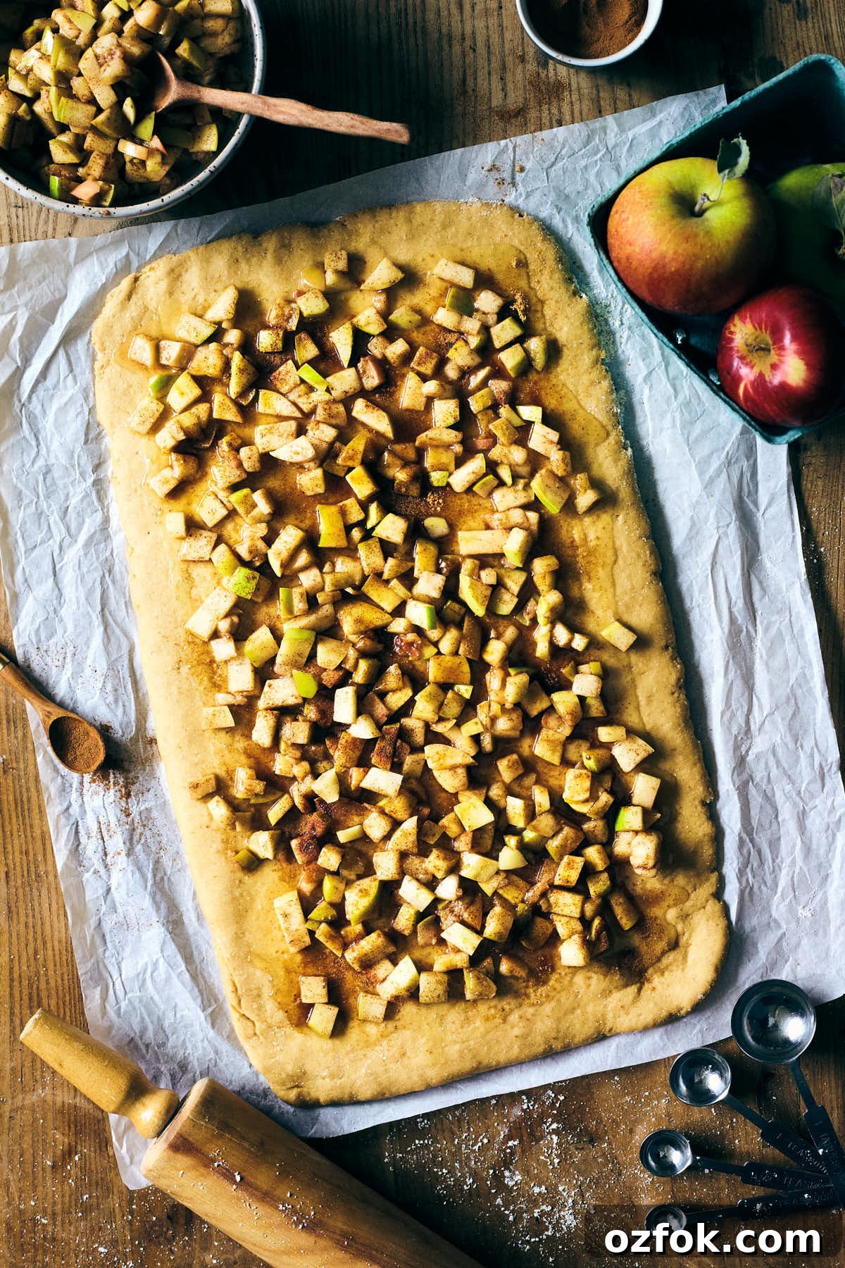 Caramel Apple Cinnamon Sticky Buns Recipe 4 Caramel apple sticky cinnamon bun filling spread across dough before baking