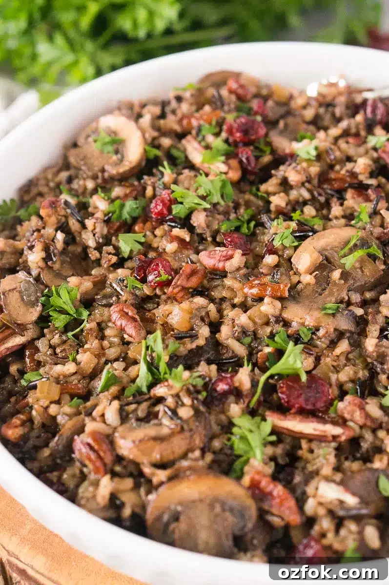 Wild Rice and Mushroom Pilaf Recipe for Flavorful Sides 9 thanksgiving mushroom wild rice side served in a white bowl