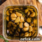 Garlic lovers rejoice: You can make homemade garlic confit and garlic oil with only a few minutes of prep time. Slowly roasting garlic cloves in olive oil allows them to become mild, caramelized, and tender enough to spread with a butter knife.
