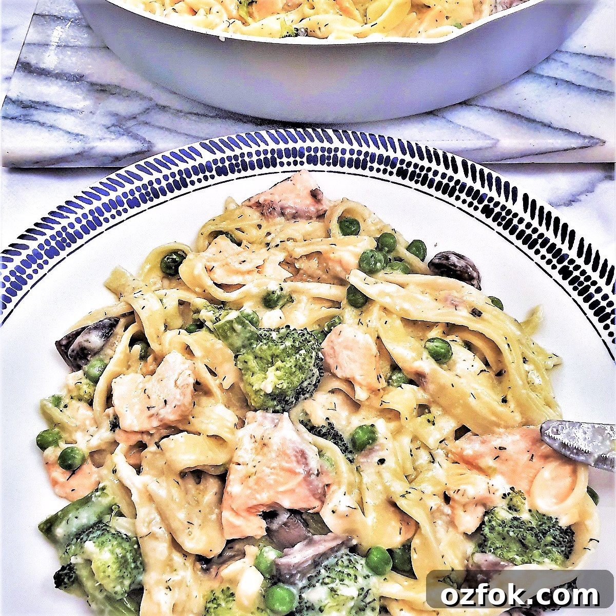 A plate of salmon and broccoli pasta