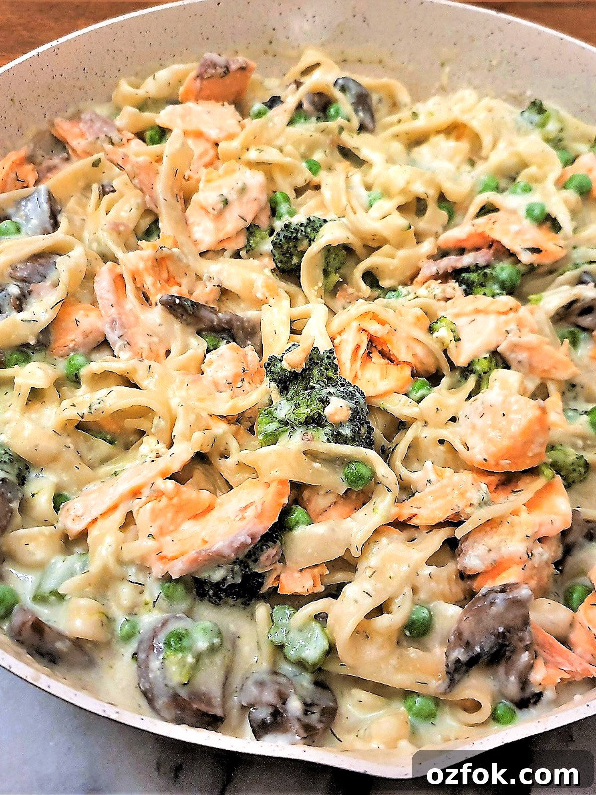 Salmon and broccoli pasta in a frying pqn.