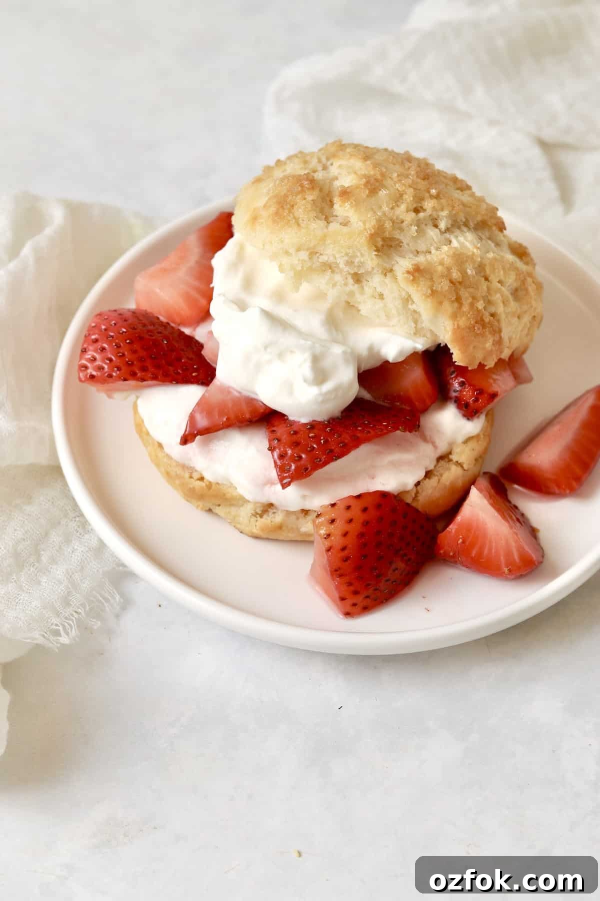 Strawberry Shortcake for Two: Individual Single-Serve Recipe 14 Individual strawberry shortcake on a plate with whipped cream and fresh strawberries.