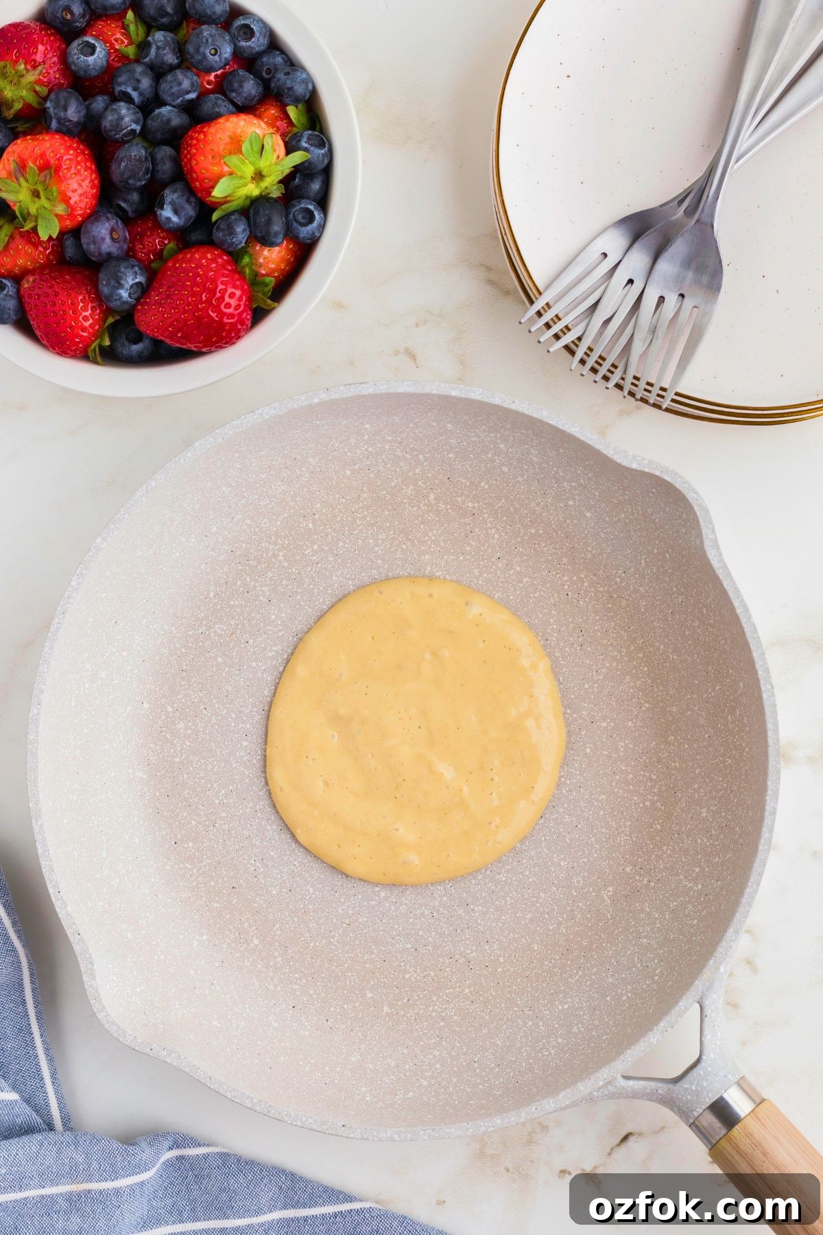 Pancake batter in the skillet as it's cooking.