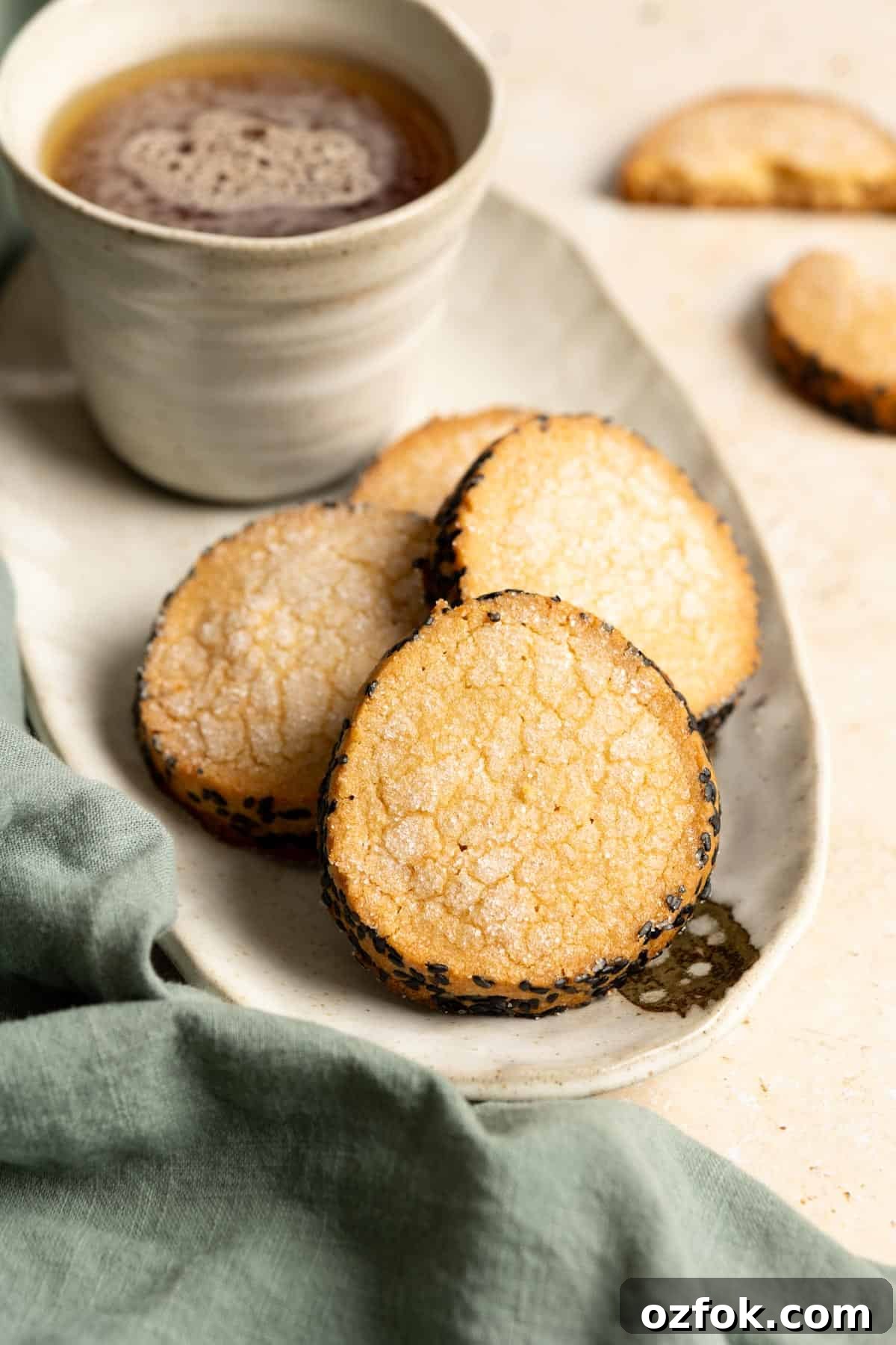 Miso Brown Sugar Shortbread Cookies Recipe for Rich, Buttery Cookies 4 Four miso shortbread cookies on a plate with a cup of tea.