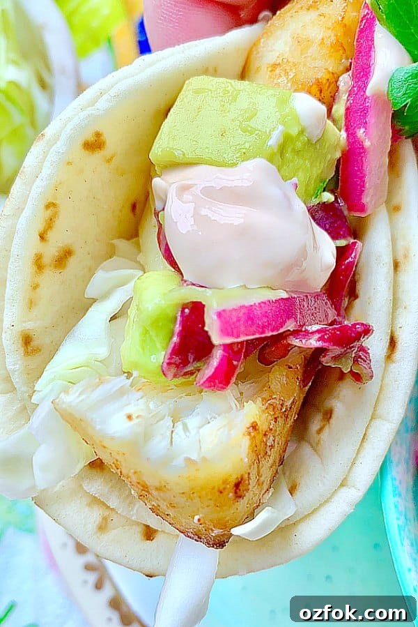 Authentic Baja Fish Tacos Guide: Flavorful Recipe & Tips 4 close up view of folded baja fish taco