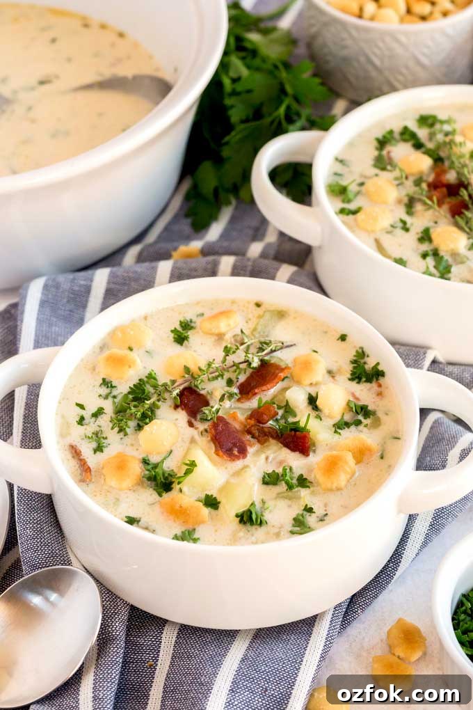 Classic New England Clam Chowder Recipe from Scratch 8 Creamy clam chowder topped with bacon an oyster crackers serve in white bowls