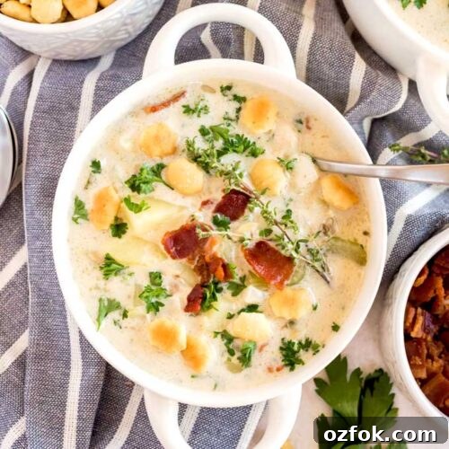 Classic New England Clam Chowder Recipe from Scratch 9 A bowl of creamy clam chowder topped with crispy bacon