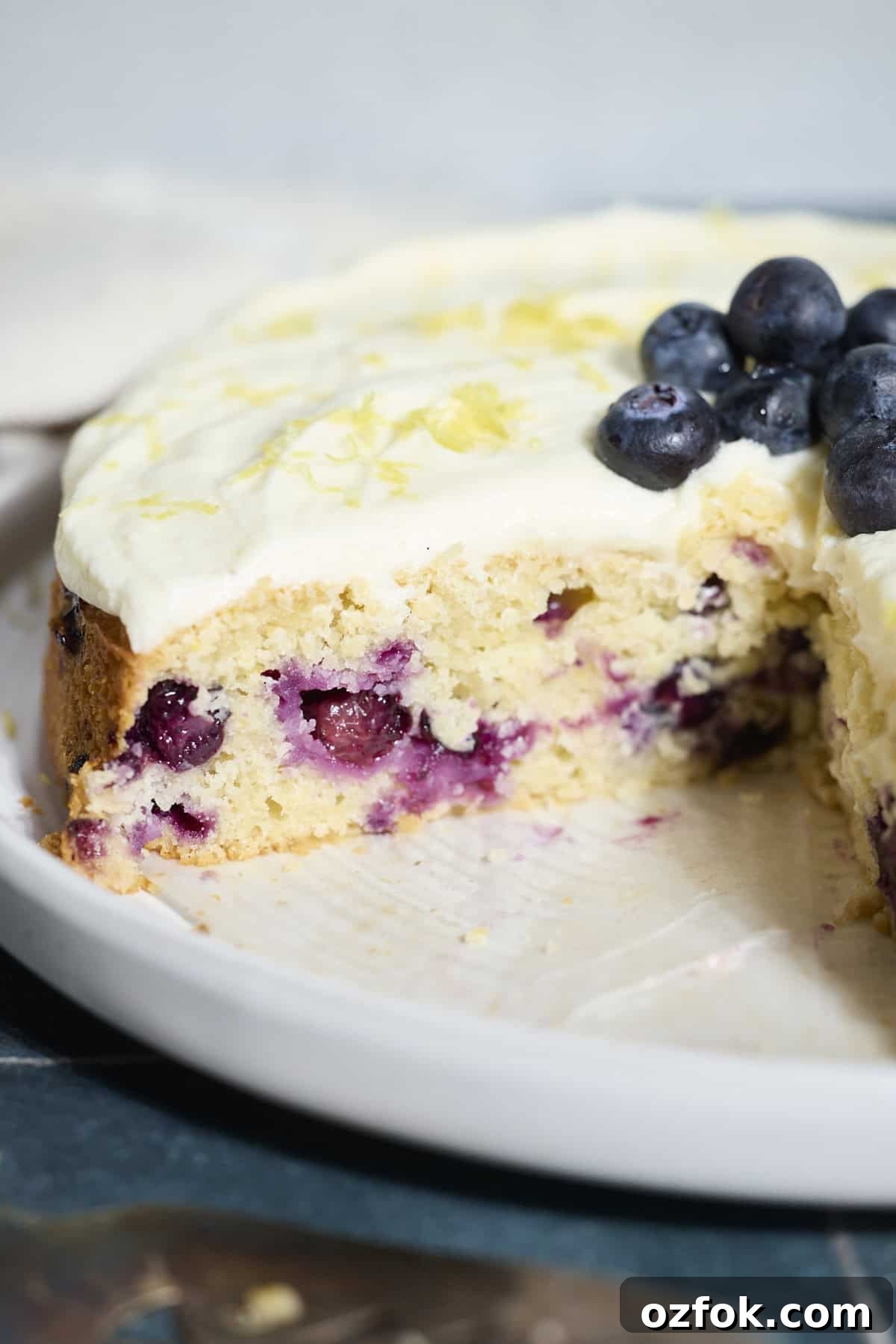 Blueberries in a slice of Sourdough Lemon Blueberry Cake.