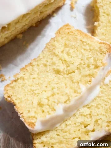 Slices of Sourdough Lemon Loaf Cake on white parchment paper.