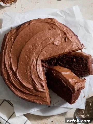 A Sourdough Chocolate Zucchini Cake with two slices leaning.