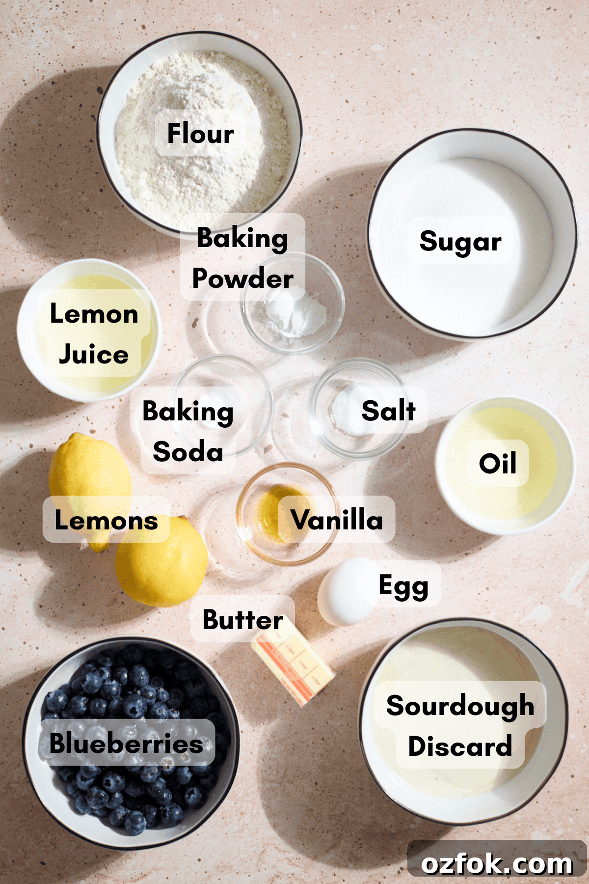 Ingredients for Sourdough Lemon Blueberry Cake in small bowls.