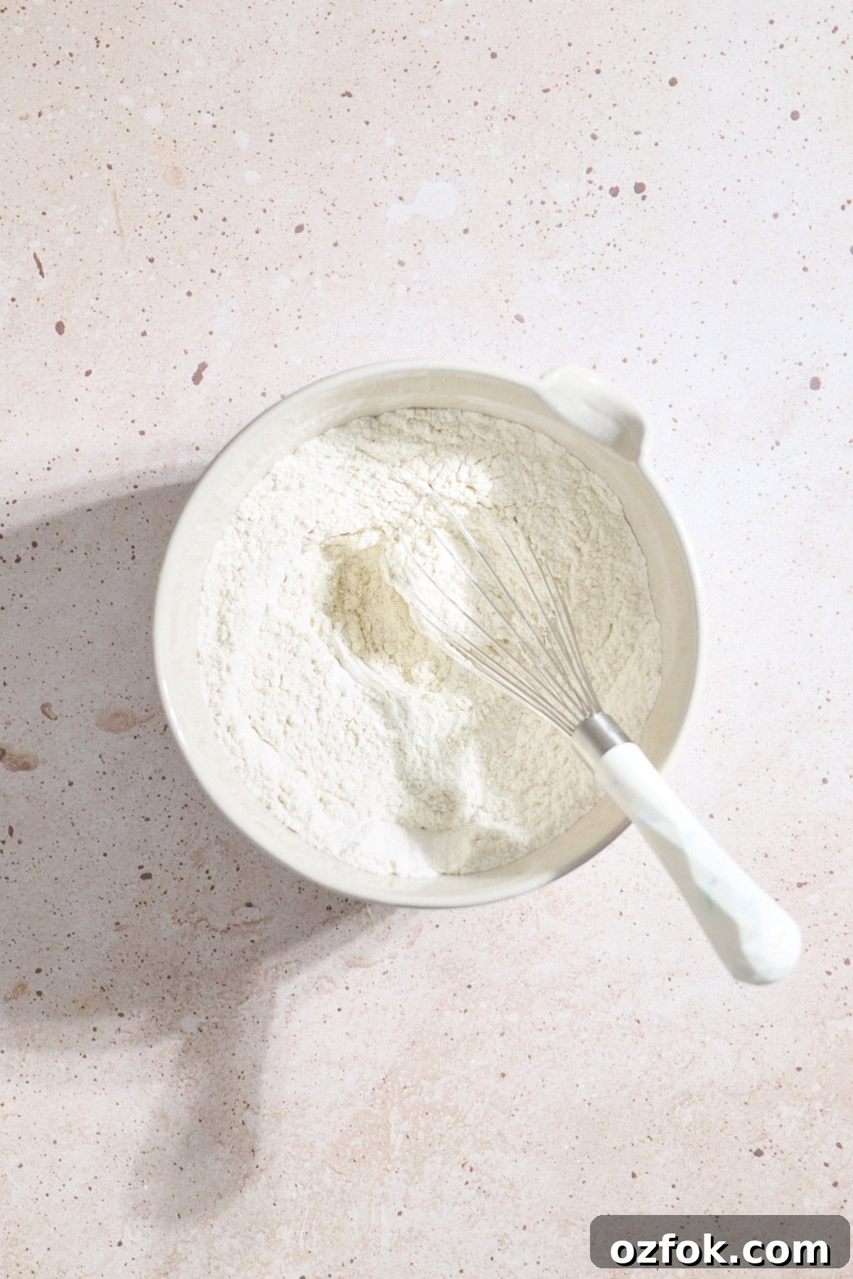 Dry ingredients mixed in a mixing bowl.
