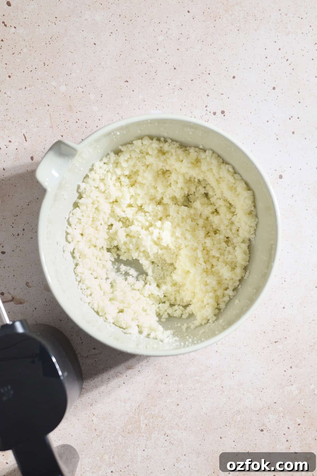 Butter and sugar creamed in a mixing bowl.