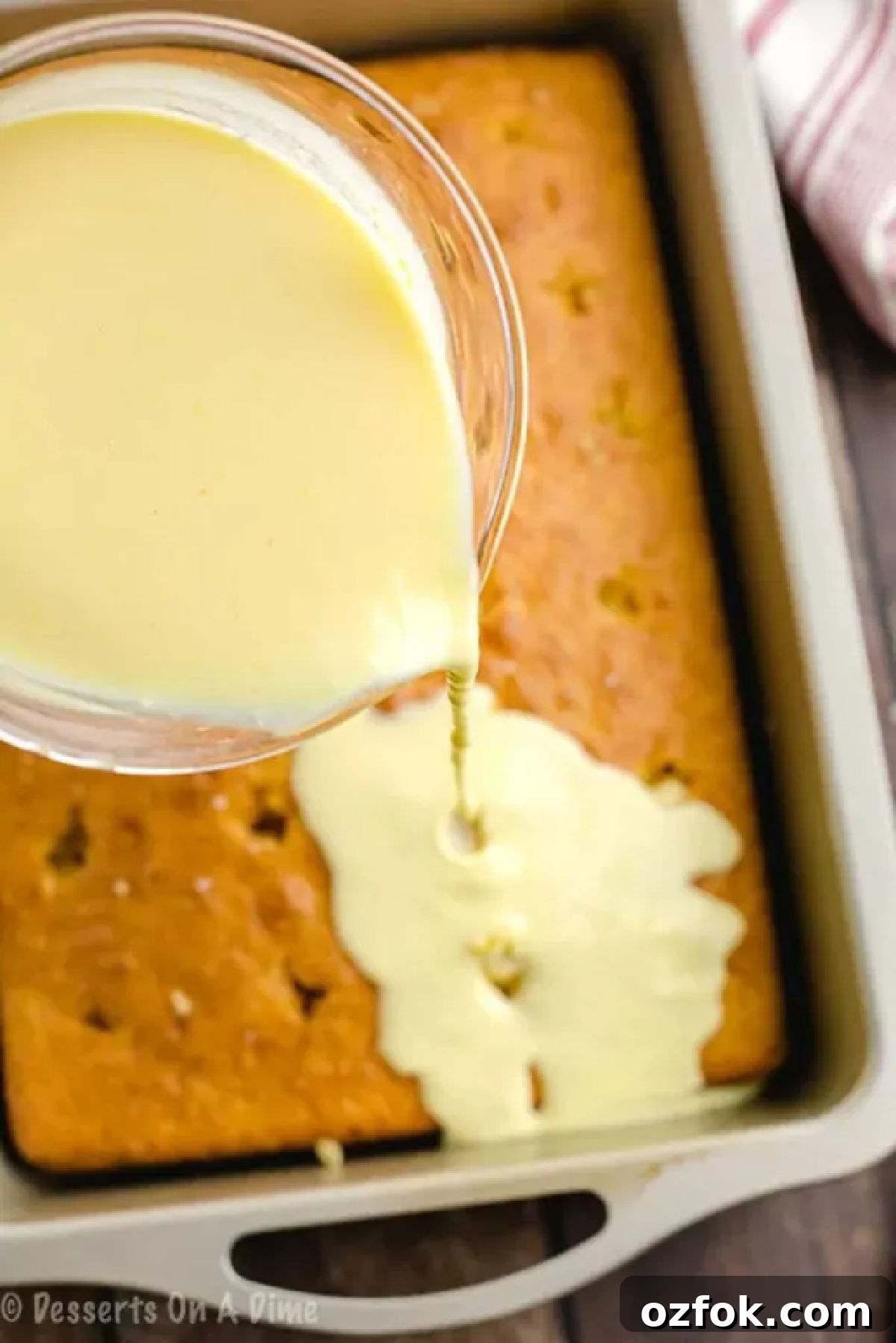 Boston Cream Poke Cake Recipe: Creamy Custard & Chocolate Drizzle 2 Pudding poured over the cake.