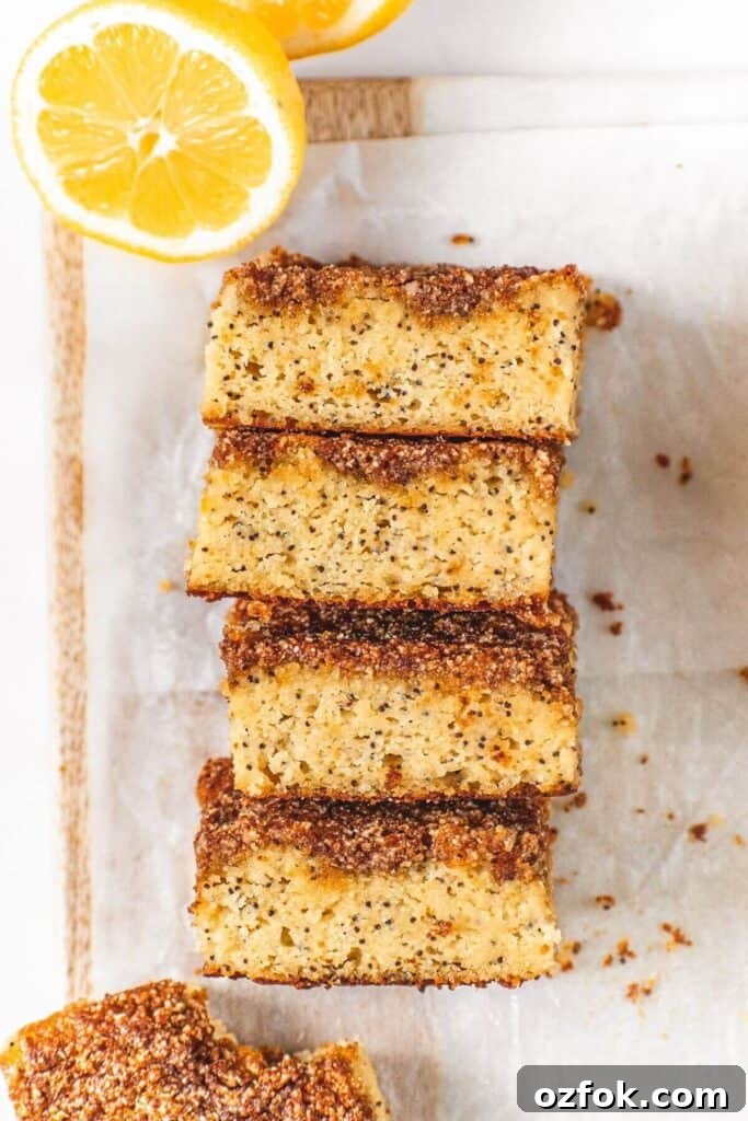 Lemon Poppy Seed Crumb Cake Recipe — Moist Zesty Dessert 2 four pieces of healthy lemon poppy seed crumble cake stacked to show light and moist texture