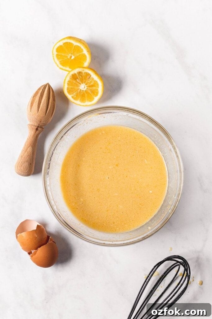 Lemon Poppy Seed Crumb Cake Recipe — Moist Zesty Dessert 6 First step to make lemon poppy seed crumb cake by mixing wet ingredients together