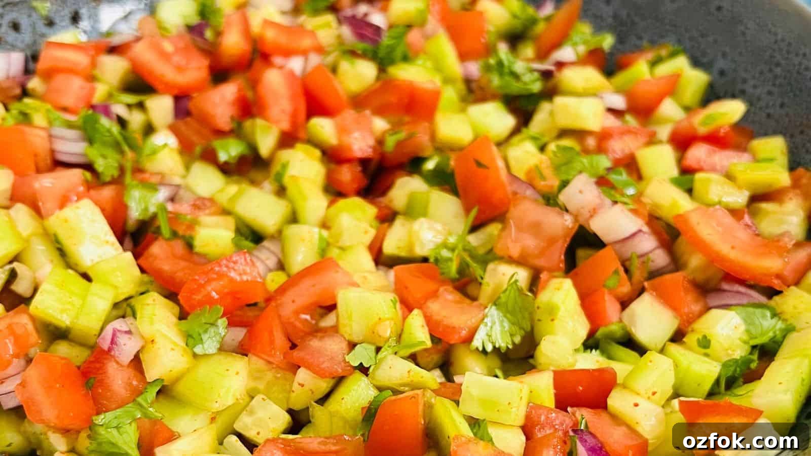 29 Irresistible Salad Recipes Everyone Will Love 18 Kachumber salad in a grey bowl.