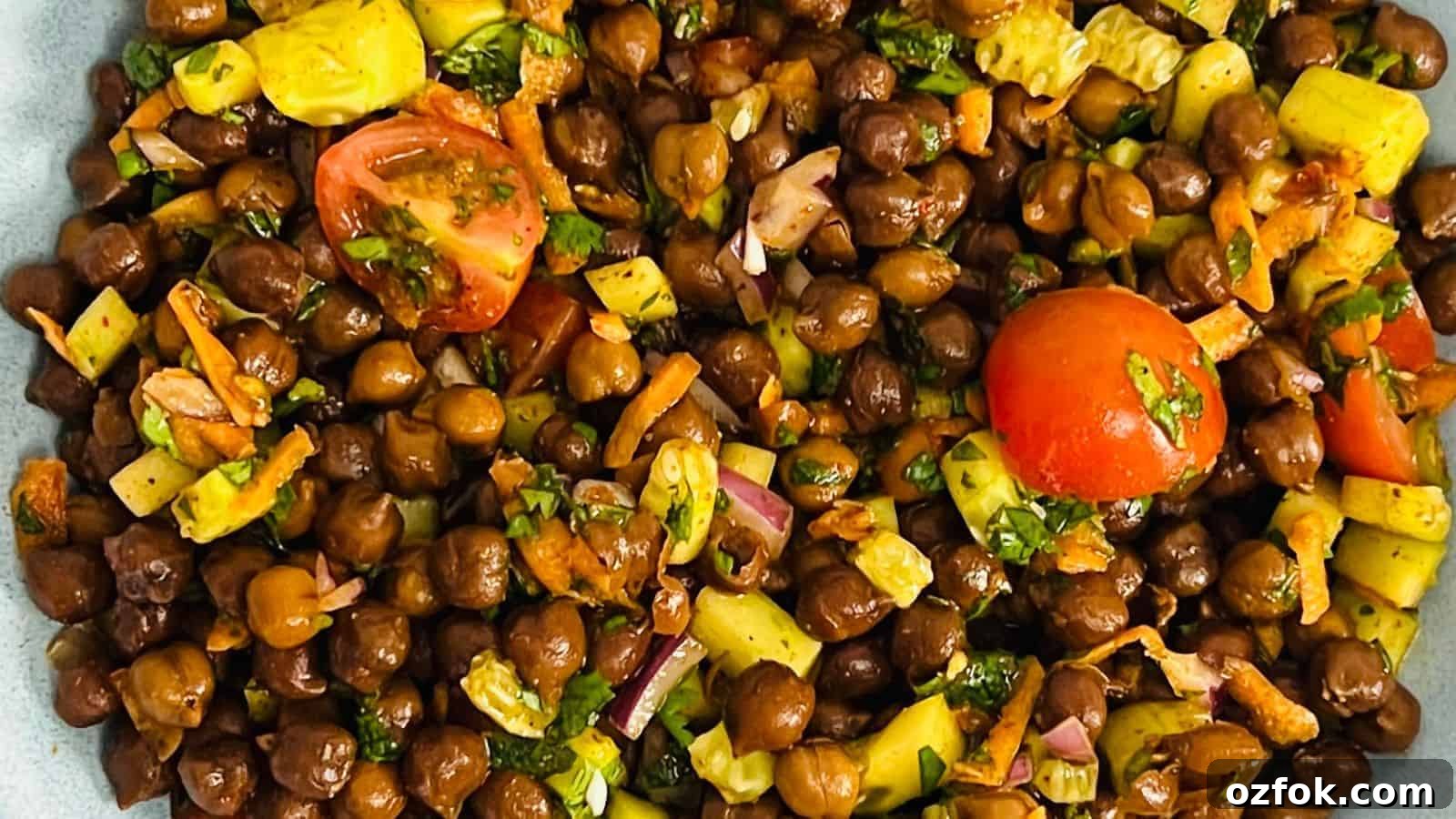 29 Irresistible Salad Recipes Everyone Will Love 20 Kala chana chaat served in a blue bowl.