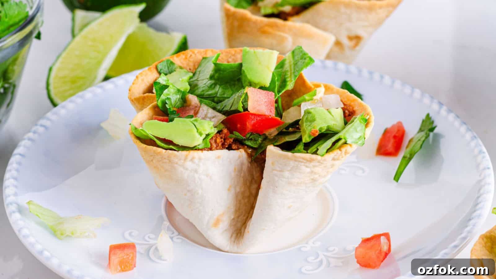 29 Irresistible Salad Recipes Everyone Will Love 4 Mexican taco salad cups on a plate.