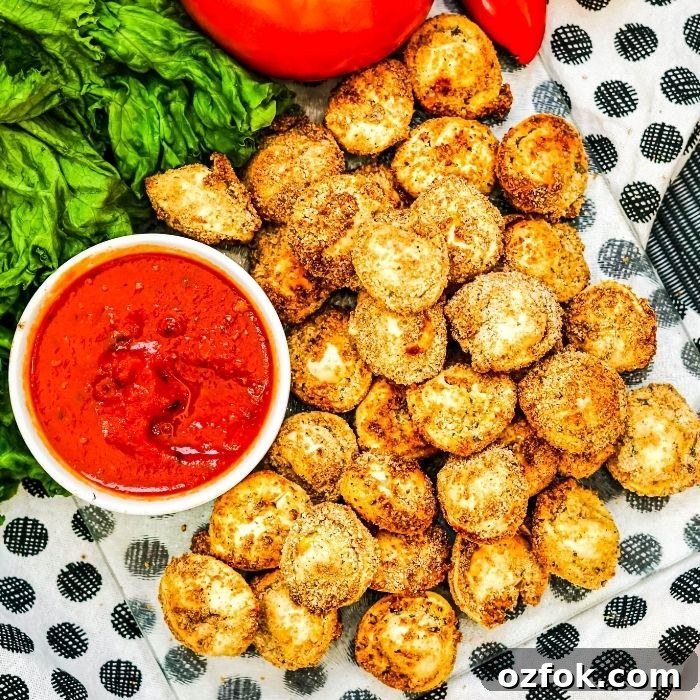 crispy tortellini on tray with marinara beside it in a bowl