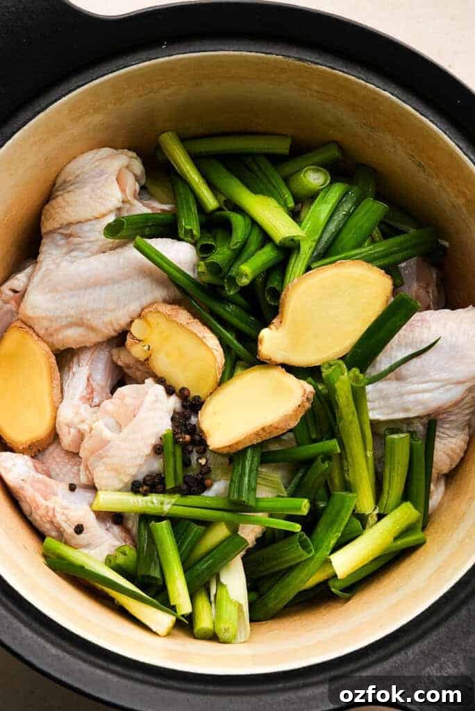Chicken stock vs broth Ingredients for chicken broth in a large pot.