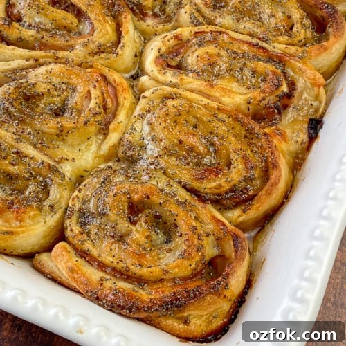 Sweet brown sugar and poppyseed glaze on baked ham and cheese roll-ups