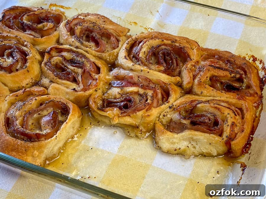 Center of pan showing glazed and baked ham and cheese roll-ups