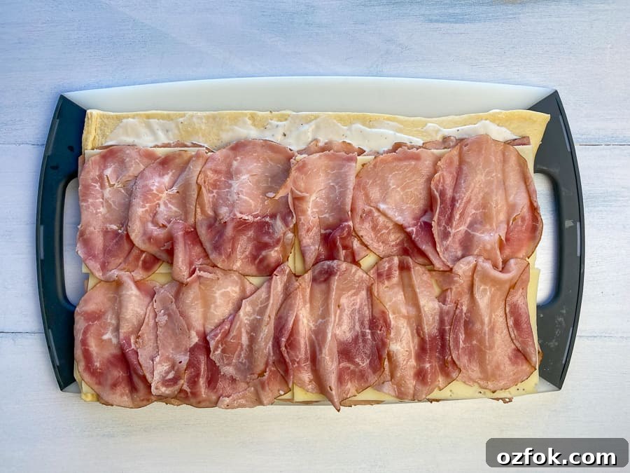 Another layer of ham added on top of Swiss for ham roll-up