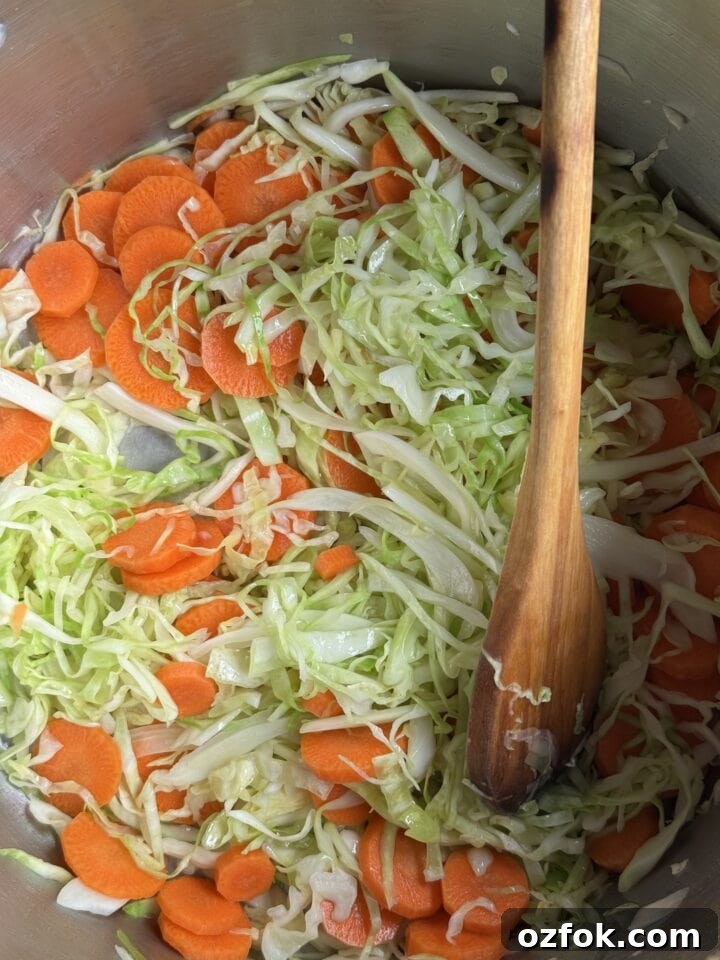 Spicy Chicken Soup Recipe: Flavorful Homemade Chicken Stew 8 a photo of carrots and cabbage cooking in a pot