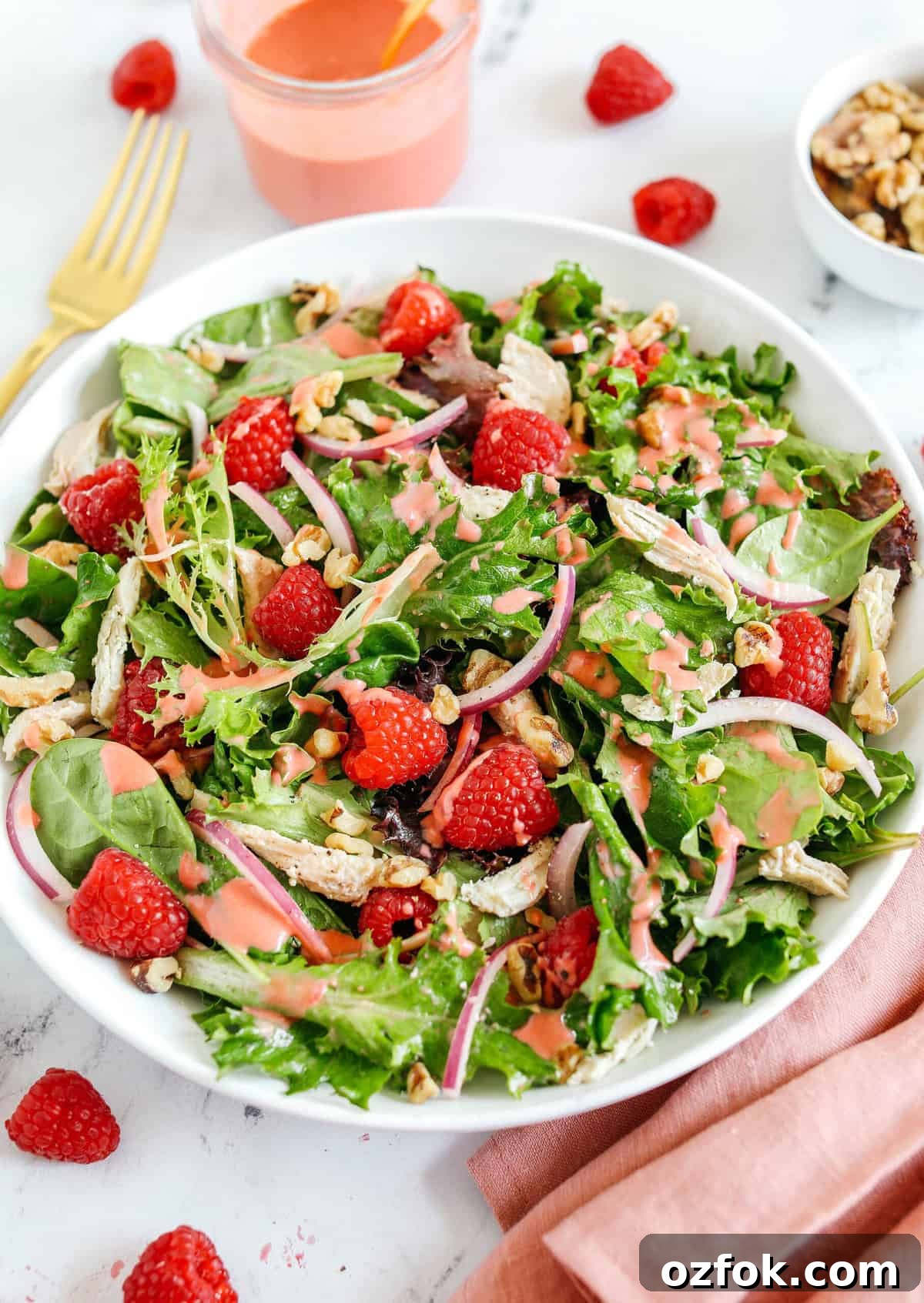 Raspberry Walnut Chicken Salad with Mixed Greens and Balsamic Vinaigrette 3 My favorite Raspberry Walnut Salad with Chicken made with leafy greens, fresh raspberries, shredded chicken, chopped walnuts, and sliced red onion all tossed with a creamy raspberry vinaigrette!