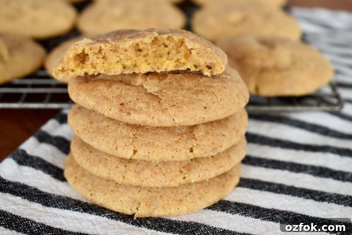 Stack of pumpkin snickerdoodle cookies on a striped towel. 