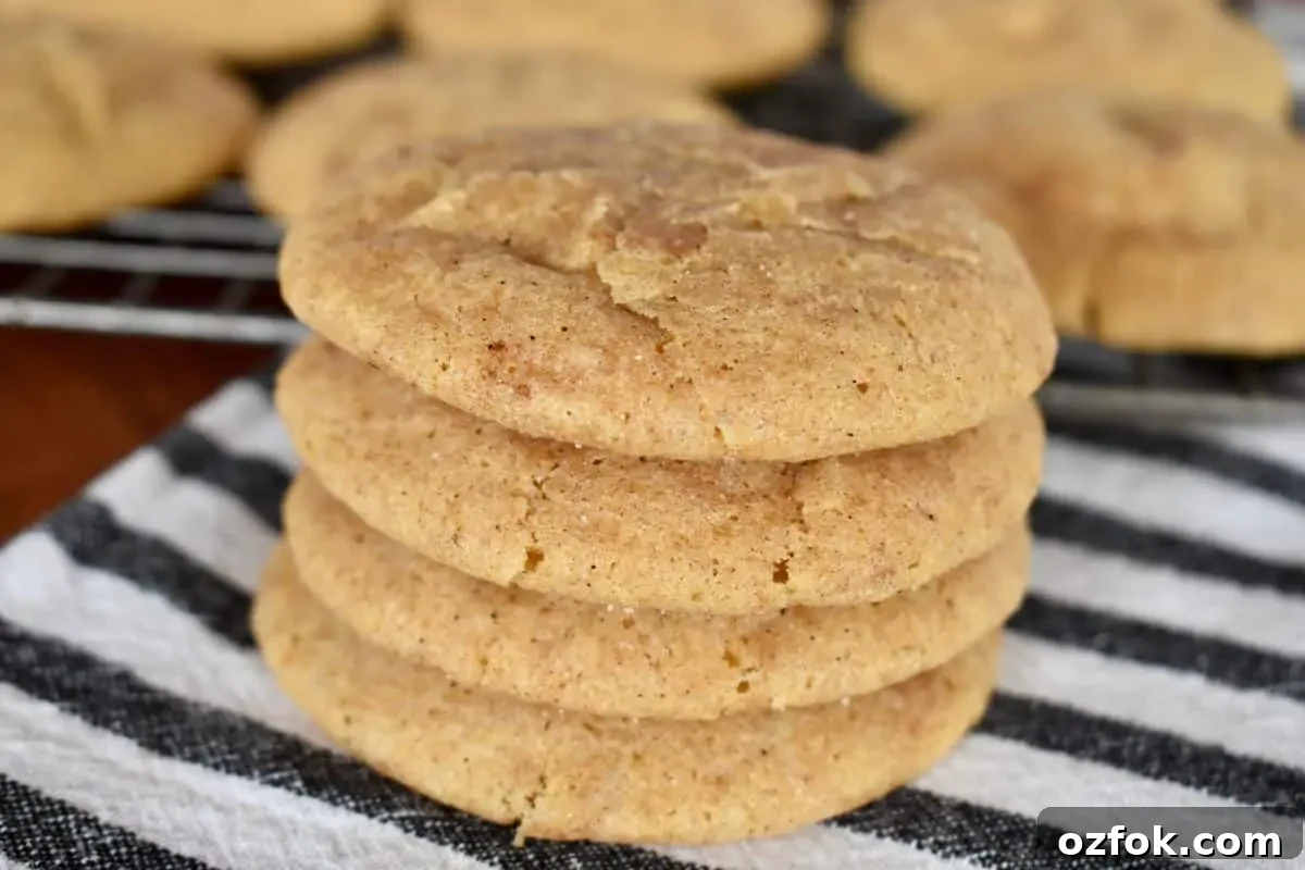 Stack of pumpkin snickerdoodles on a striped napkin. 